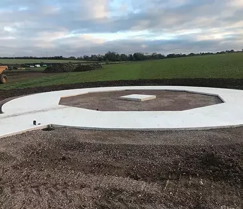 This image shows a freshly laid circular concrete base, part of specialist groundworks tailored to equestrian projects, ensuring a strong and precise foundation.